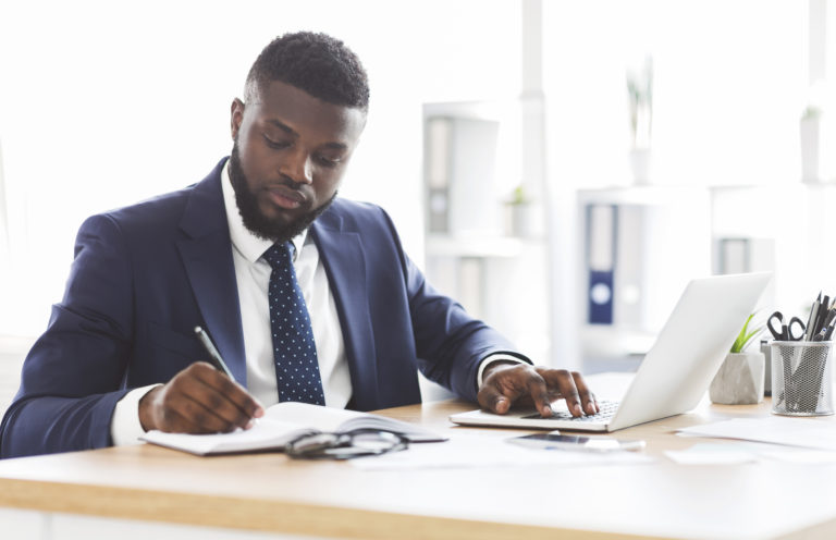 Successful black businessman working hard in office
