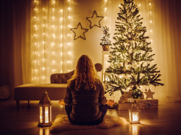 Woman sit on sheepskin rug and meditating. Tranquil relaxing Chr