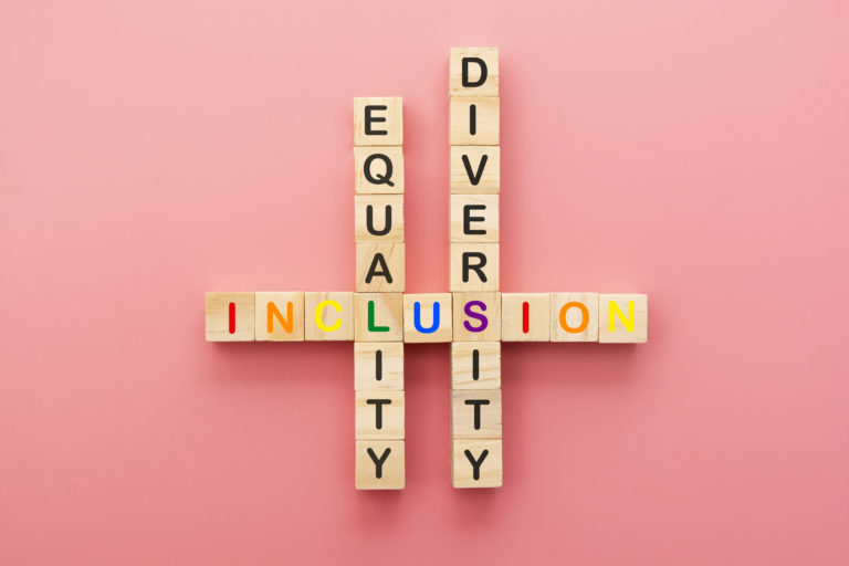 Inclusion, diversity and equality concept. Lgbtq abstract letters on wooden cubes over pink background.