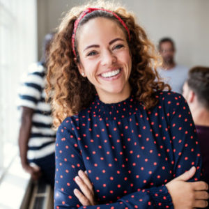 Smiling female designer standing in an modern office