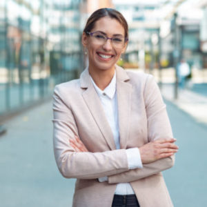 Portrait of young business woman with glasses standing outdoors